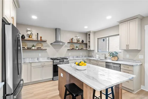 a kitchen with a sink a stove and chairs