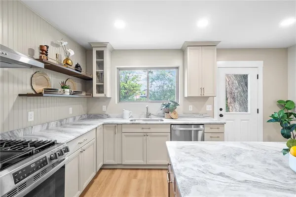 a kitchen with a sink stove and cabinets