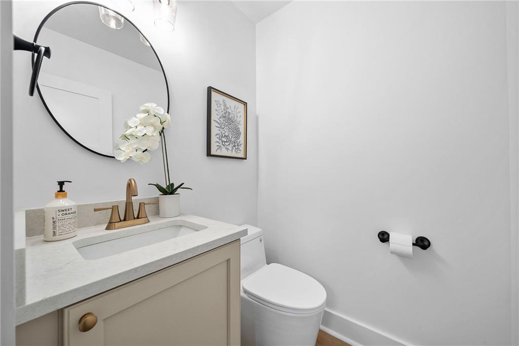 1431 Adams Street Pittsburgh, PA 15233 - Photo 15 of 42 a bathroom with a sink a toilet and a mirror