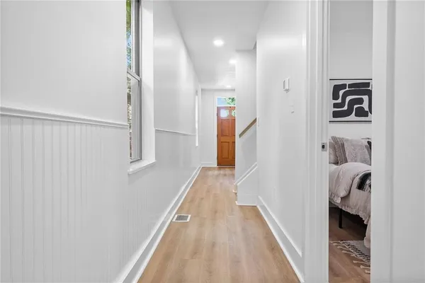 a view of hallway with wooden floor