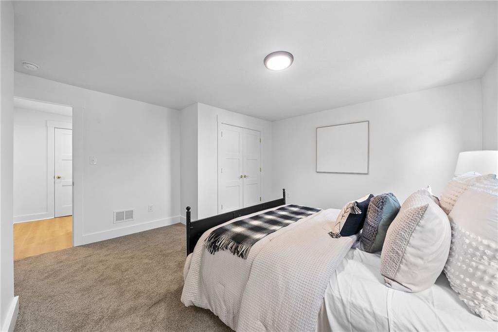 1431 Adams Street Pittsburgh, PA 15233 - Photo 25 of 42 a bedroom with a bed and a lamp