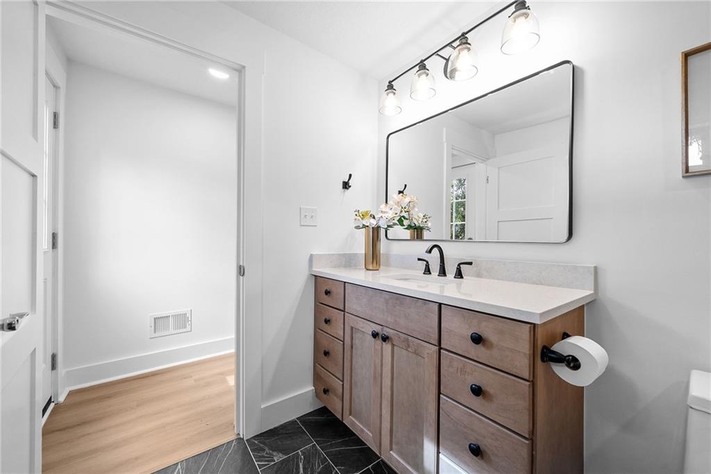 1431 Adams Street Pittsburgh, PA 15233 - Photo 27 of 42 a bathroom with a sink vanity and mirror