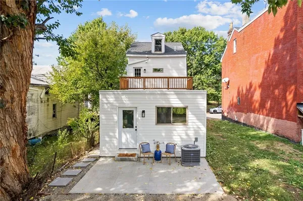 a backyard of a house with outdoor seating