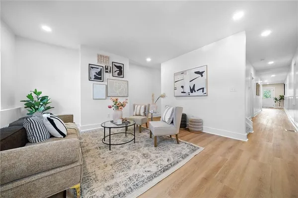 a living room with furniture and wooden floor