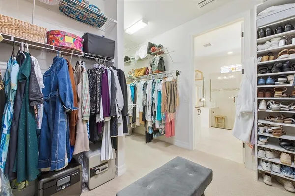 a bedroom with a bed and a flat tv screen on dresser