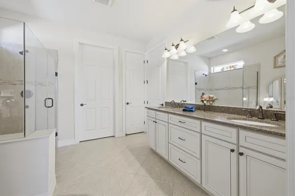 a bathroom with a granite countertop sink a toilet and a bathtub