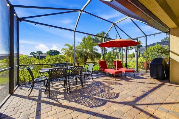 a view of a patio with a table chairs and a umbrella