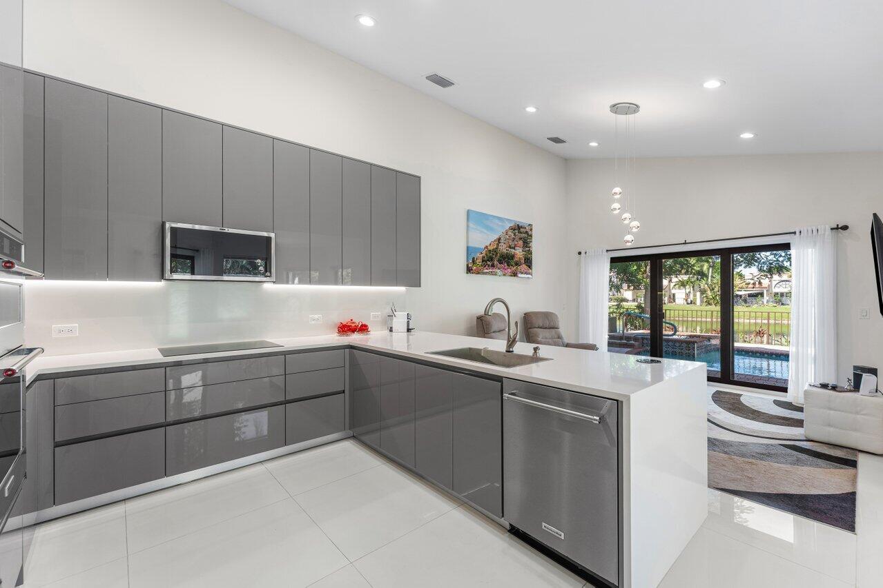 23419 Mirabella Circle South Boca Raton, FL 33433 - Photo 12 of 57 a kitchen with sink cabinets and window