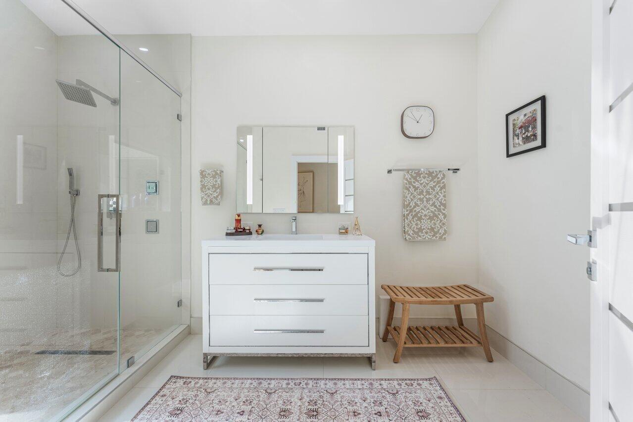 23419 Mirabella Circle South Boca Raton, FL 33433 - Photo 31 of 57 a bathroom with a sink mirror and a shower