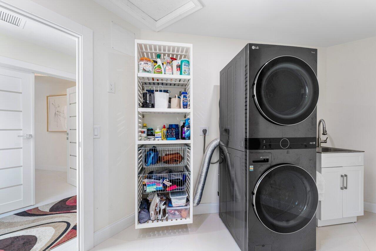 23419 Mirabella Circle South Boca Raton, FL 33433 - Photo 36 of 57 a view of a storage & utility room with dryer and washer