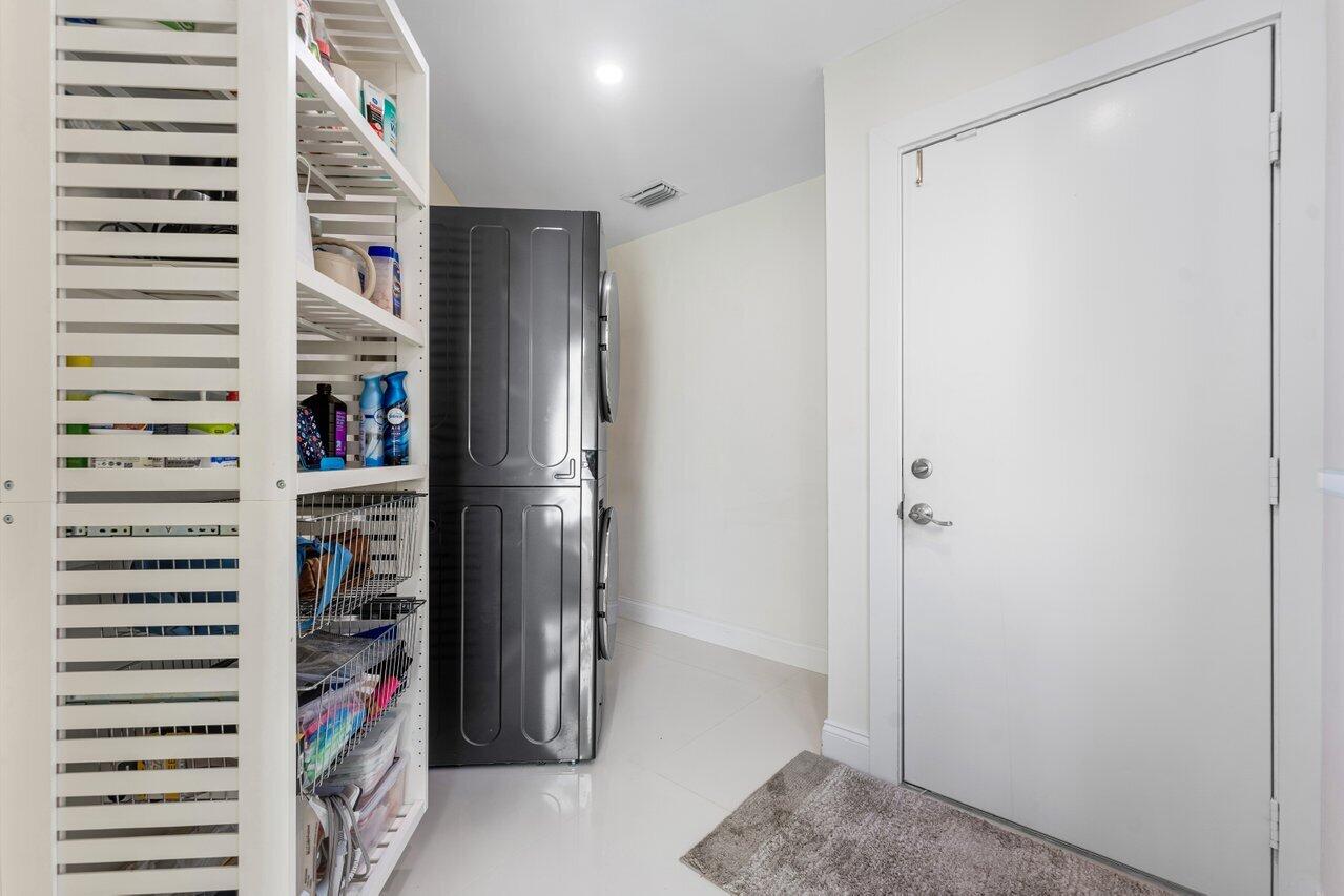 23419 Mirabella Circle South Boca Raton, FL 33433 - Photo 37 of 57 a view of walk in closet with clothes and shoes