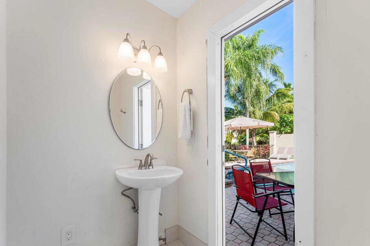 23419 Mirabella Circle South Boca Raton, FL 33433 - Photo 40 of 57 a bathroom with a sink and a mirror