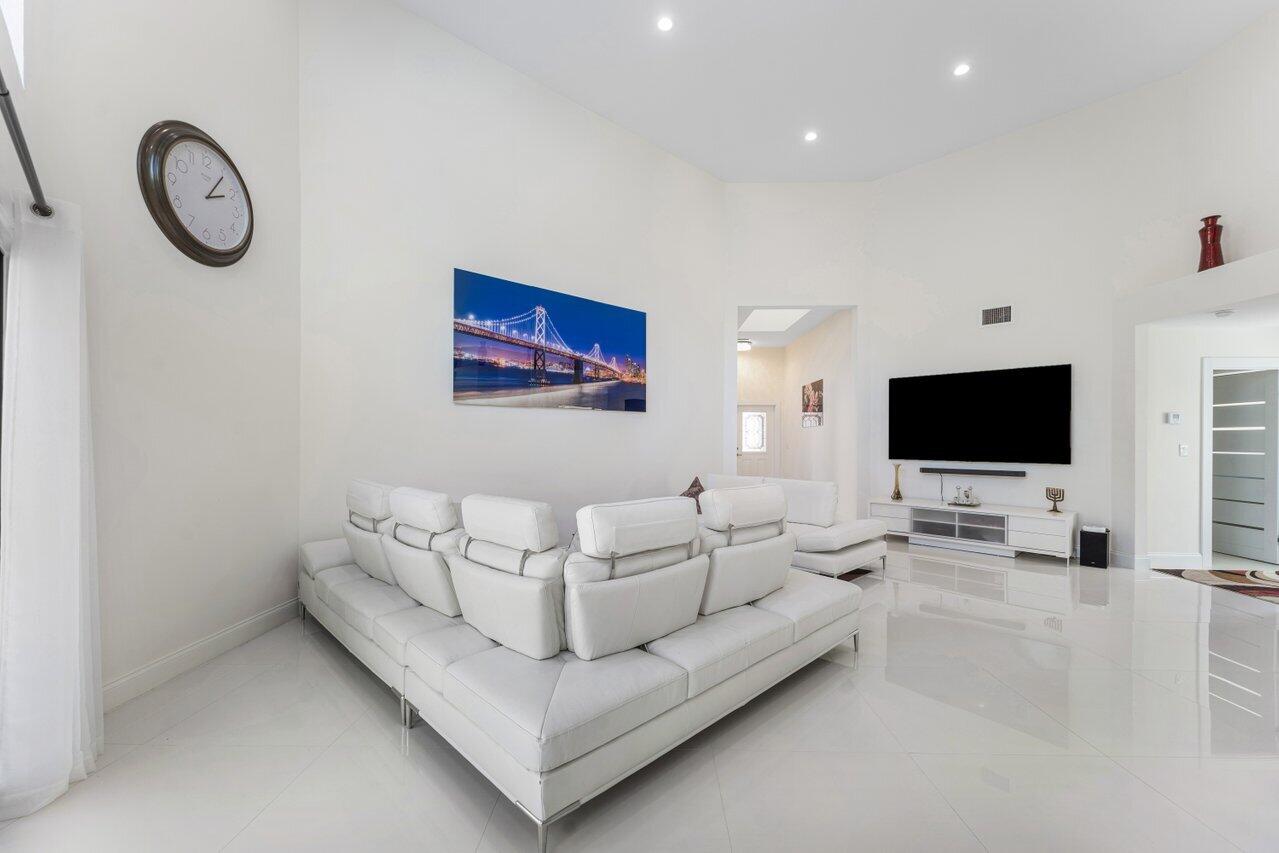 23419 Mirabella Circle South Boca Raton, FL 33433 - Photo 7 of 57 a living room with furniture and a flat screen tv