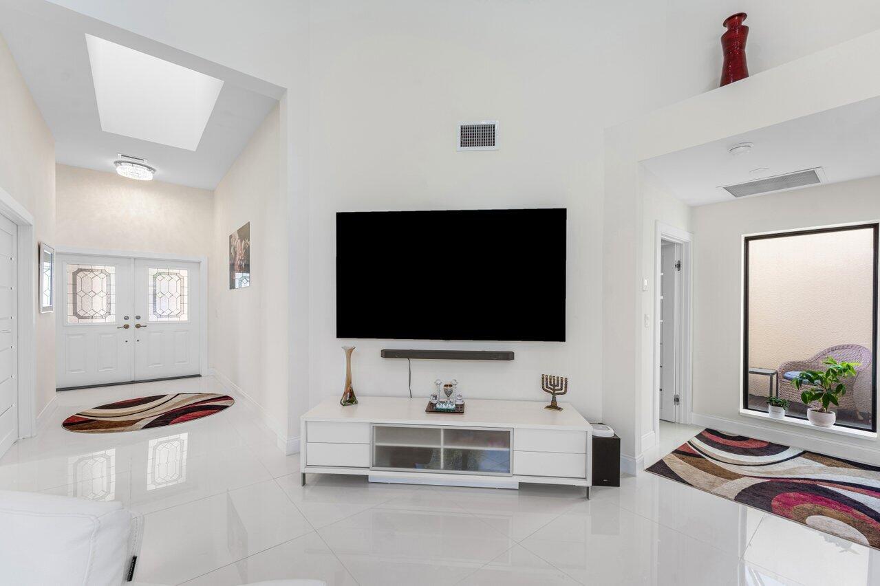 23419 Mirabella Circle South Boca Raton, FL 33433 - Photo 8 of 57 a living room with furniture and a flat screen tv