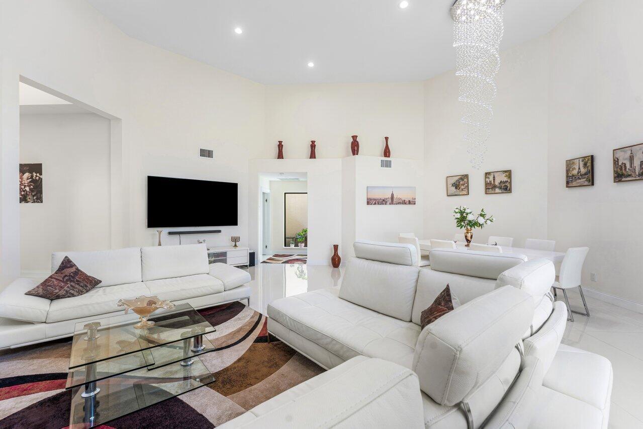 23419 Mirabella Circle South Boca Raton, FL 33433 - Photo 9 of 57 a living room with furniture and a flat screen tv