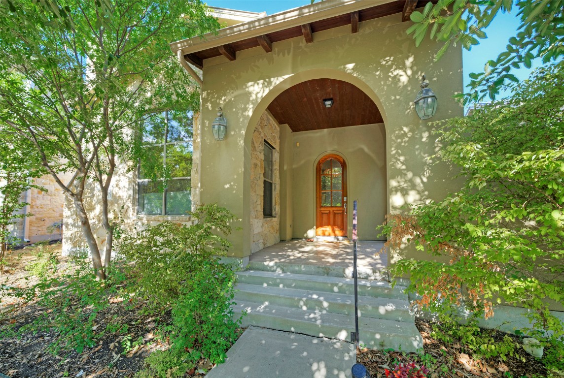 View of exterior entry with stone siding and stucco siding