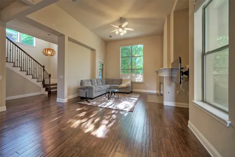 a living room with furniture and a wooden floor
