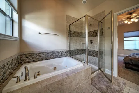 a bathroom with a tub and a shower