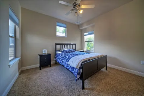 a bed sitting in a bedroom next to a window