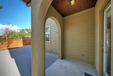 a view of a small space with wooden floor and city view