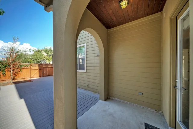 a view of a small space with wooden floor and city view
