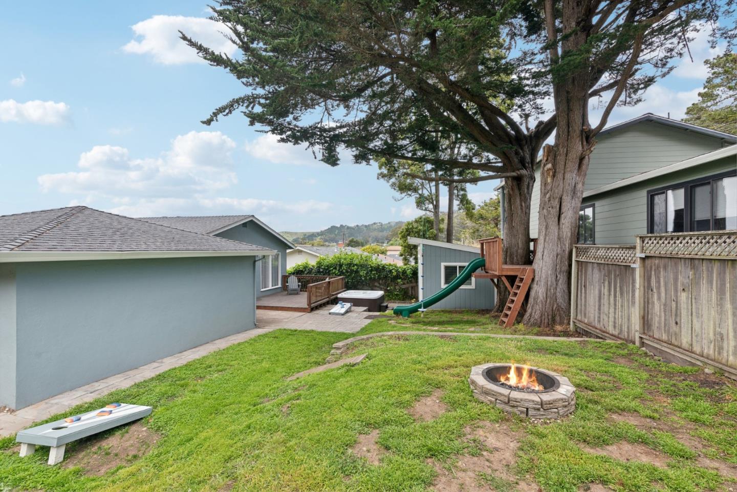 965 Monte Verde Drive Pacifica, CA 94044 - Photo 29 of 34 a view of a backyard with table and chairs under an umbrella