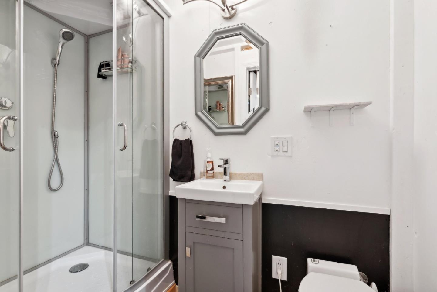 965 Monte Verde Drive Pacifica, CA 94044 - Photo 30 of 34 a bathroom with a sink a mirror and a shower