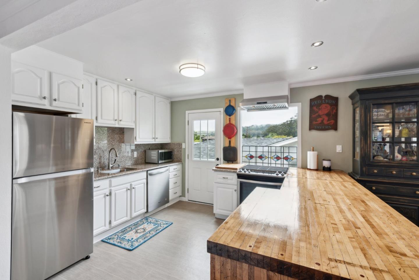 965 Monte Verde Drive Pacifica, CA 94044 - Photo 4 of 34 a kitchen with granite countertop a refrigerator stove top oven and sink