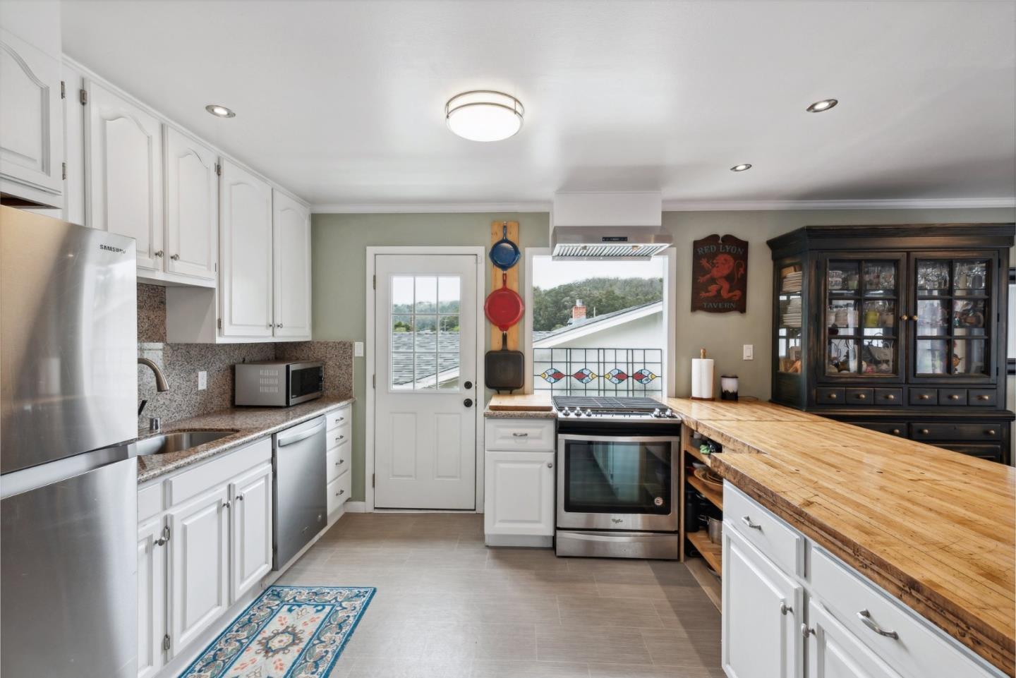 965 Monte Verde Drive Pacifica, CA 94044 - Photo 5 of 34 a kitchen with stainless steel appliances granite countertop a stove and a refrigerator