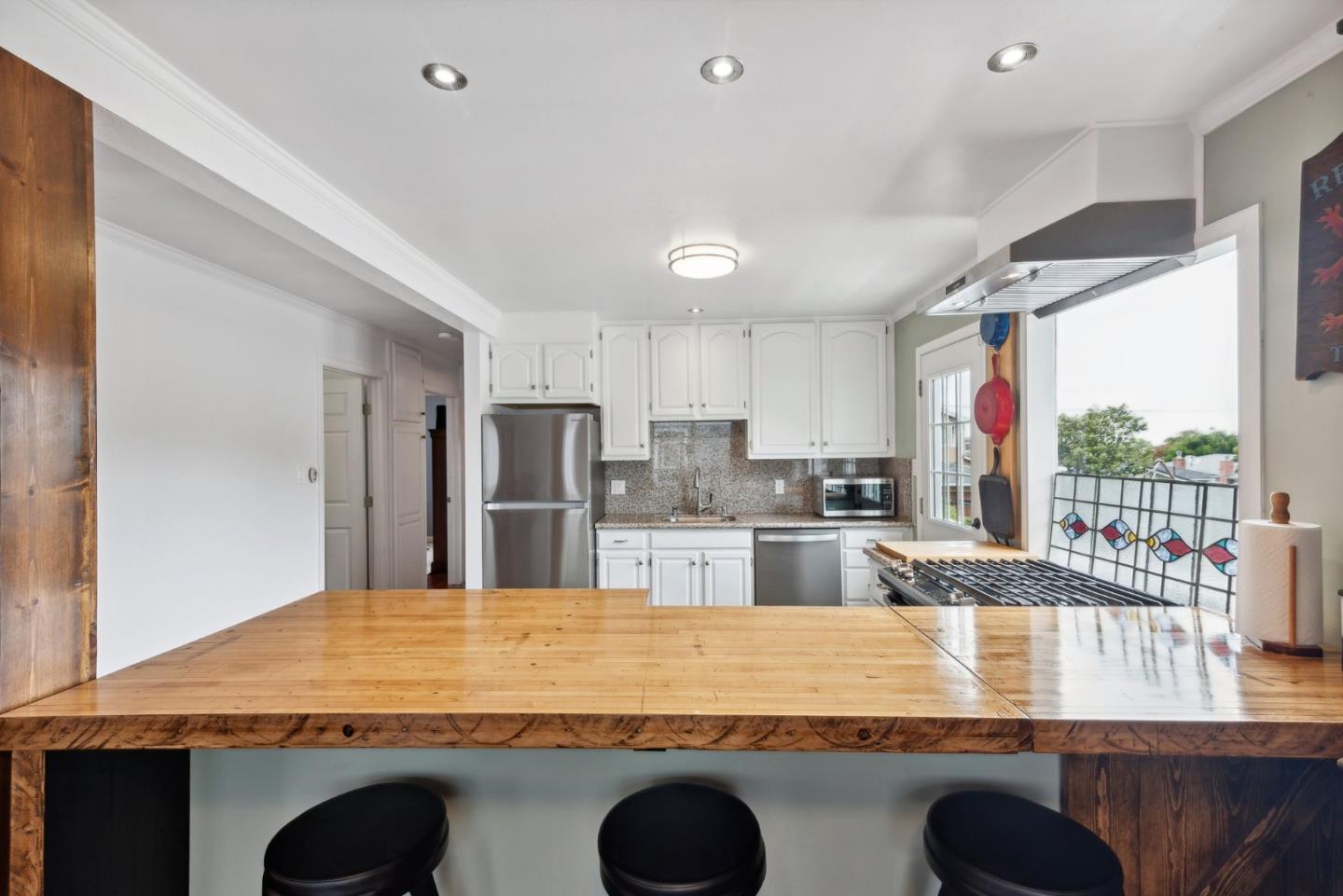 965 Monte Verde Drive Pacifica, CA 94044 - Photo 8 of 34 a large kitchen with kitchen island a sink stainless steel appliances and cabinets
