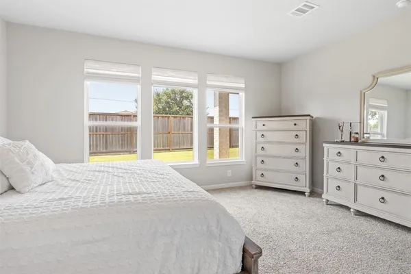 a bedroom with a bed and flat screen tv