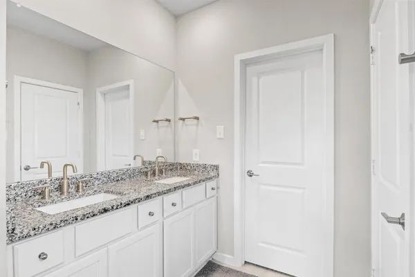 a bedroom with furniture and a wooden floor