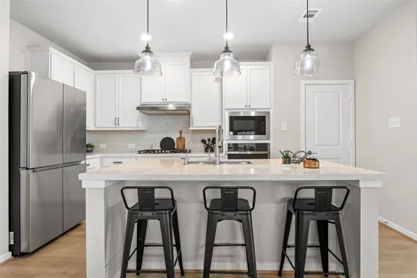 a living room with furniture windows and a flat screen tv