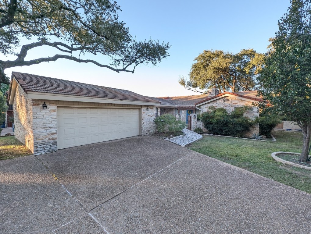 208 Crescent Bluff Lakeway, TX 78734 - Photo 1 of 21 a view of a house with a yard and garage