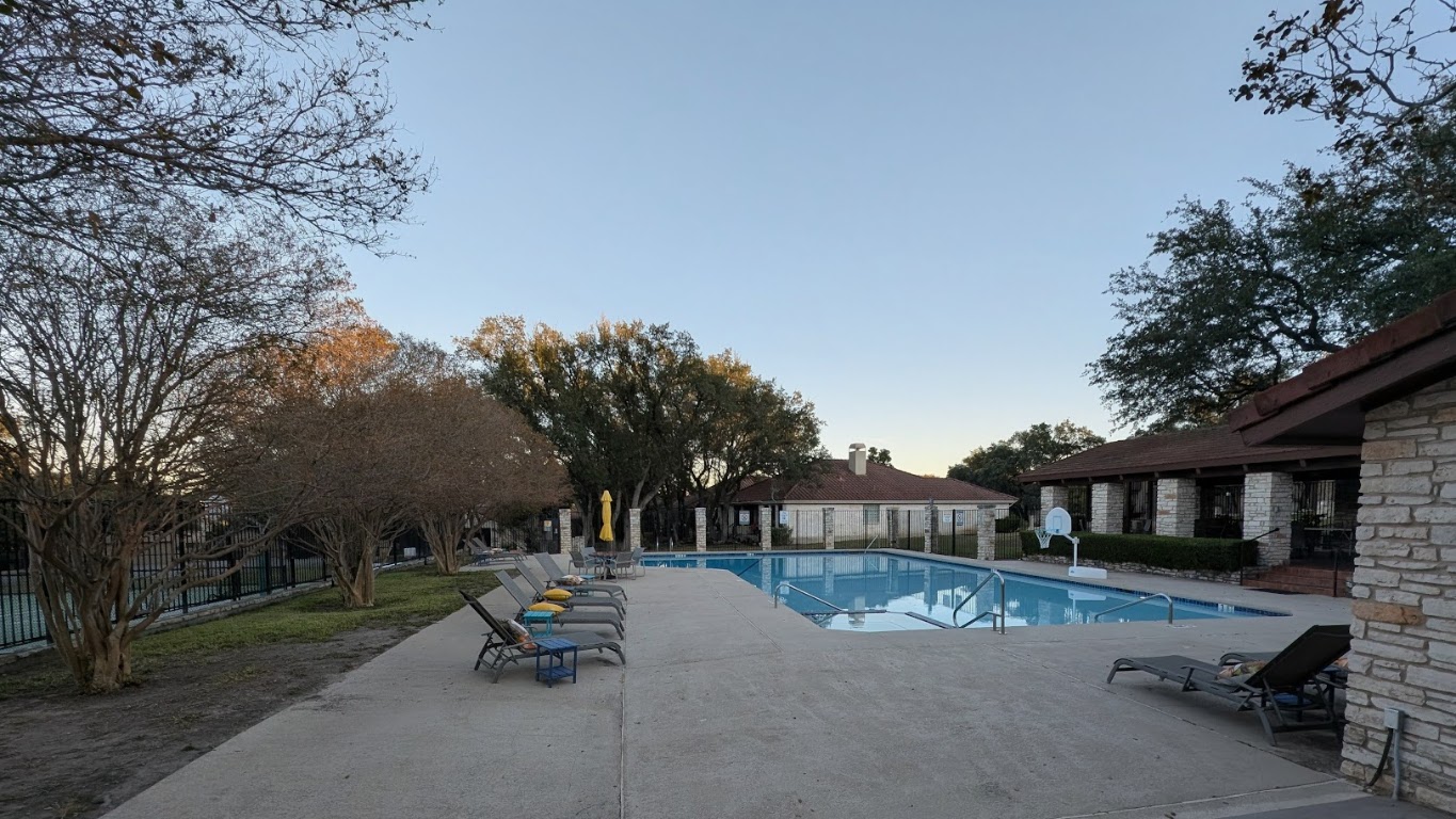 208 Crescent Bluff Lakeway, TX 78734 - Photo 19 of 21 a view of a patio with a table and chairs under an umbrella