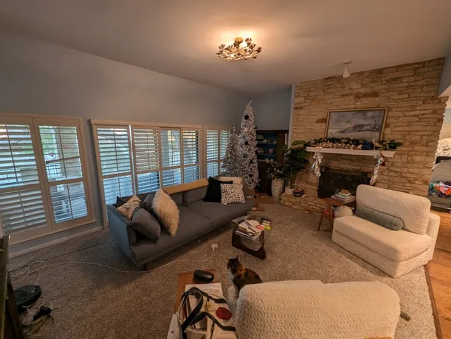 a living room with furniture fireplace and a flat screen tv