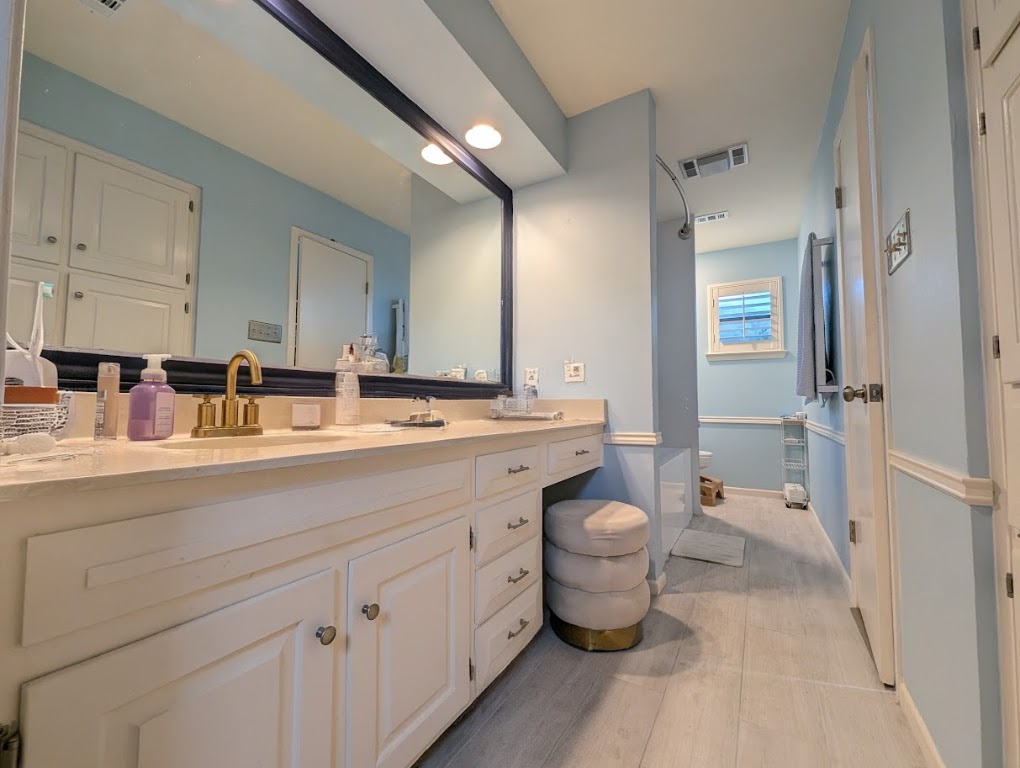 208 Crescent Bluff Lakeway, TX 78734 - Photo 8 of 21 a bathroom with a double vanity sink toilet and shower