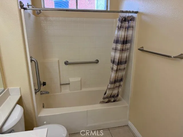 a bathroom with a shower and a toilet