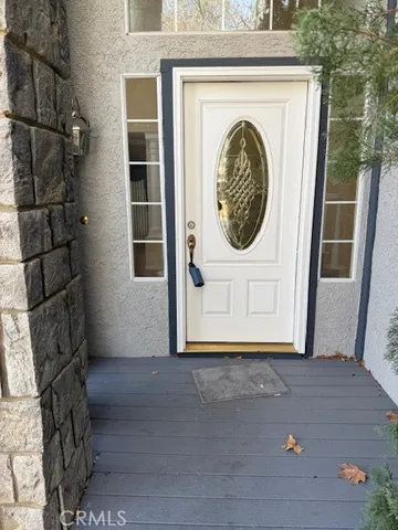 a view of a door of a house with a porch