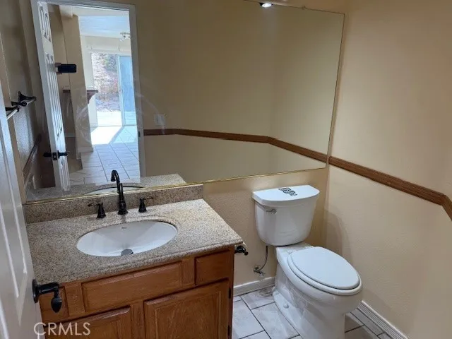 an empty room with wooden floor fireplace and windows