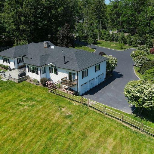 an aerial view of a house with swimming pool garden and patio
