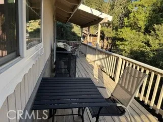 a view of balcony with wooden floor and outdoor seating