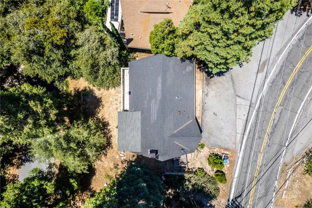an aerial view of a house with a yard and garden