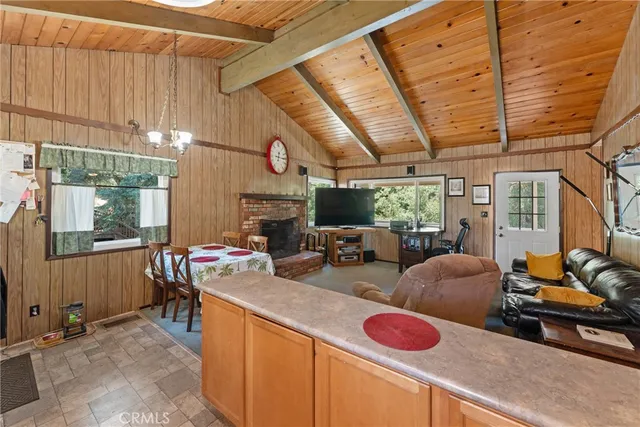 a room with furniture a large window and flat screen tv