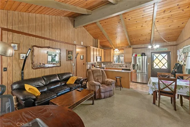 a living room with lots of furniture and a chandelier
