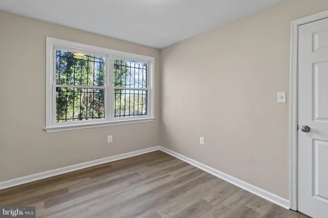 a view of a room with wooden floor and windows