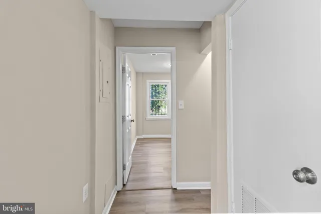 a view of a hallway with wooden floor