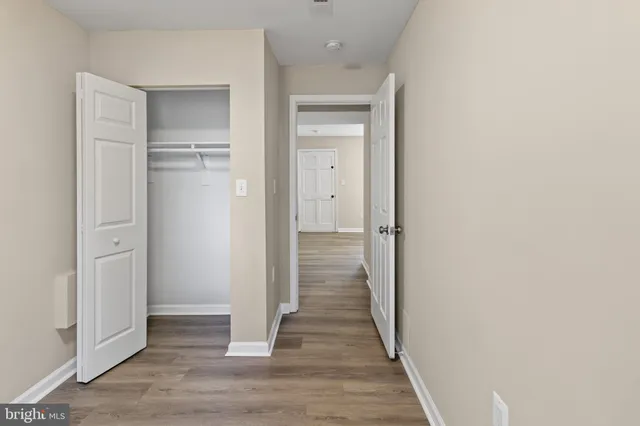 a view of a hallway with wooden floor