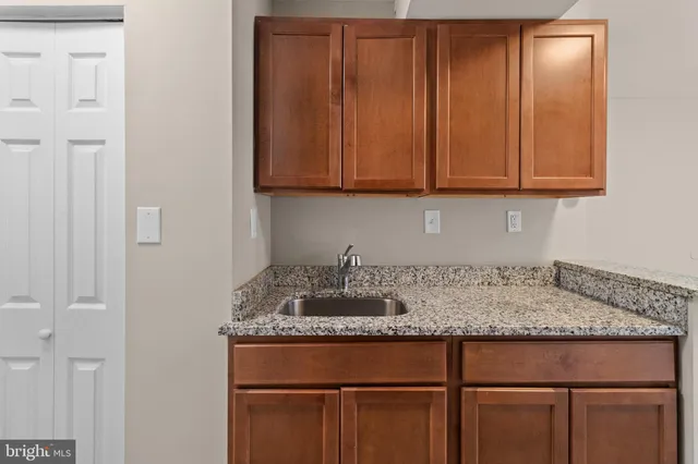 a kitchen with granite countertop cabinets and sink
