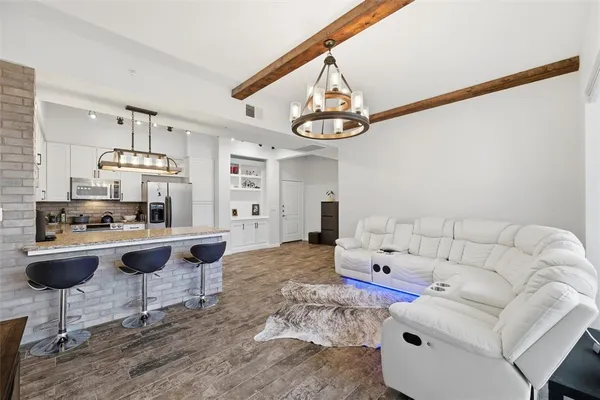 a living room with furniture and kitchen view